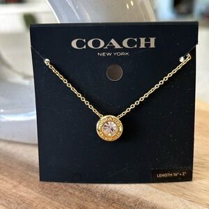 Coach Goldtone Circle Pendant with Pink Stone